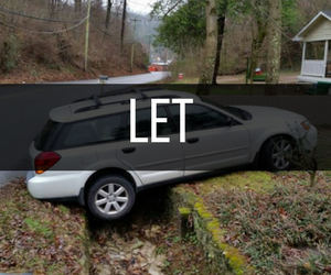 A white car stuck in a ditch 